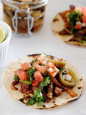 image: flat lay of steak tacos with chimichurri sauce
