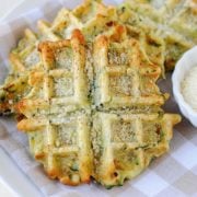 Zucchini and Parmesan Savory Waffle on napkins with parmesan on the side