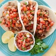 overhead view of shredded beef tacos with pico de gallo