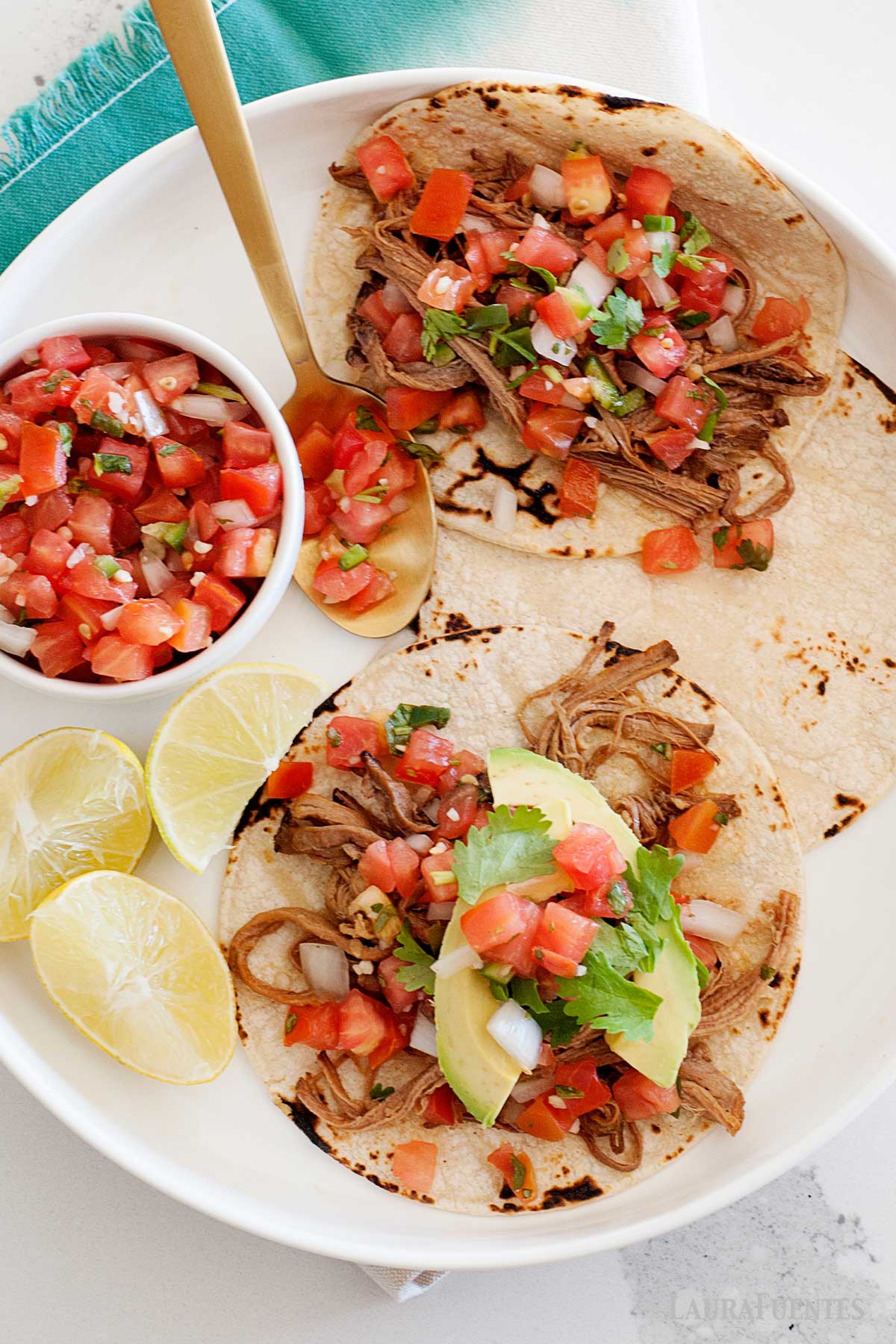 overhead view of shredded beef tacos with pico de gallo