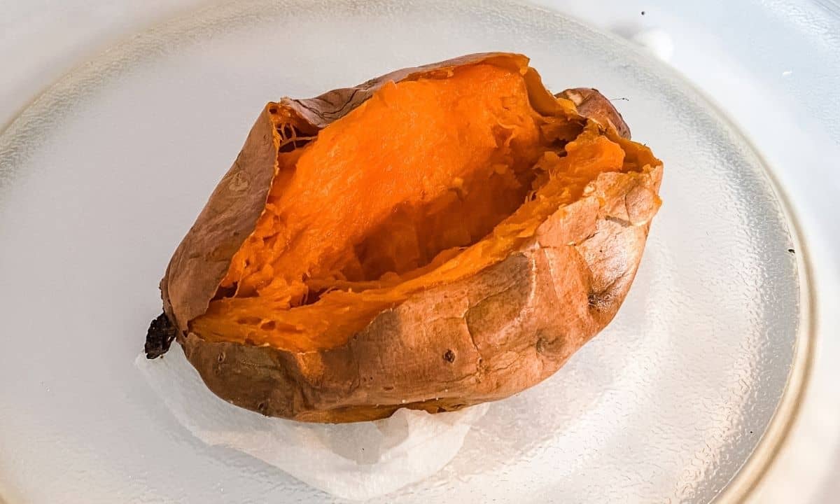 cooked sweet potato in the microwave, sliced in the center