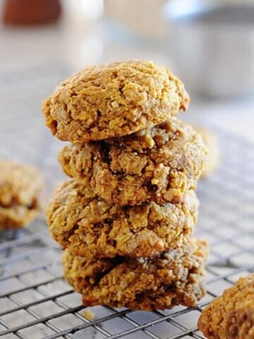 a stack of pumpkin breakfast cookies on a cooling rack