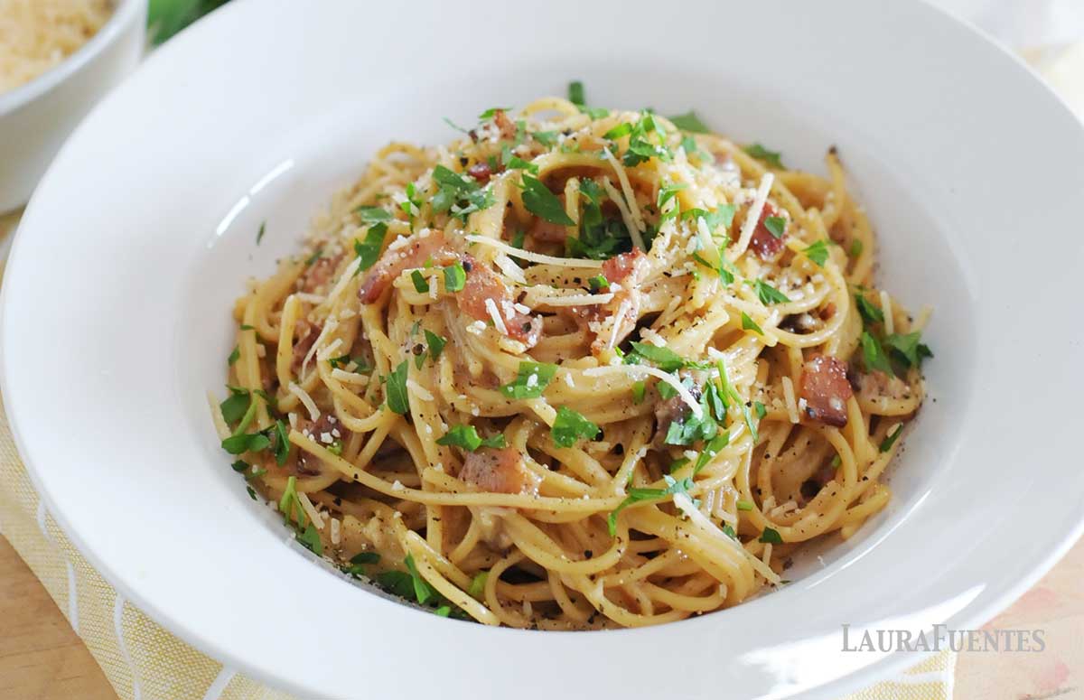 closeup of carbonara pasta in a large white bowl