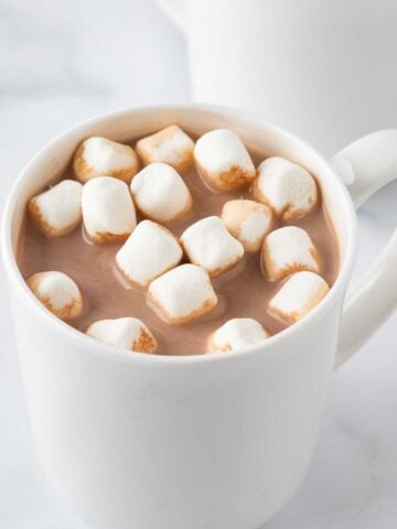 overhead view of a cup of homemade hot cocoa topped with mini marshmallows
