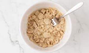 overhead view of cinnamon crumble topping for coffee cake muffins in a bowl