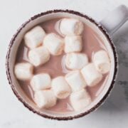 white mug of hot cocoa topped with mini marshmallows