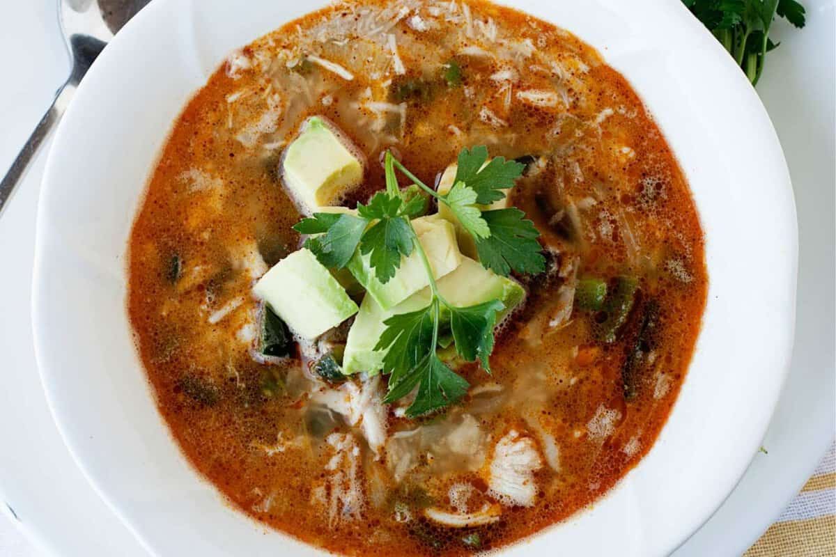 top view of a bowl of turkey chili topped with avocado