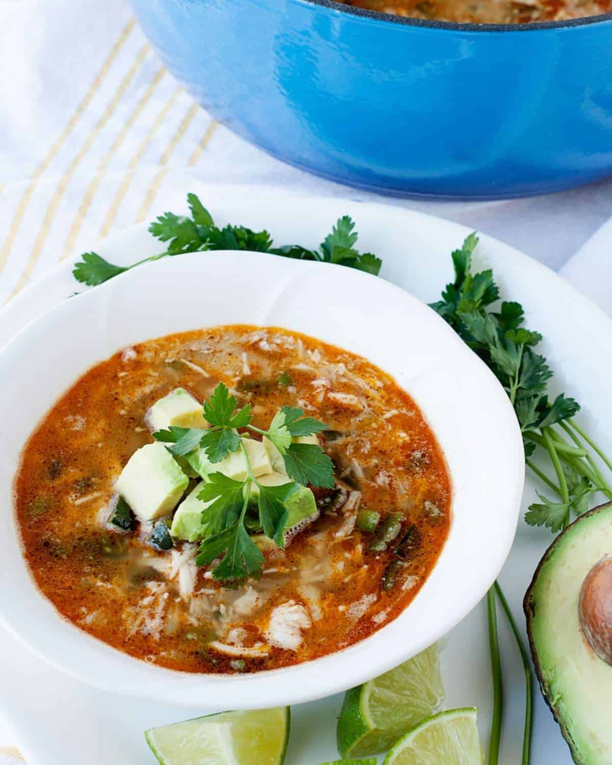 a bowl of turkey chili topped with avocado