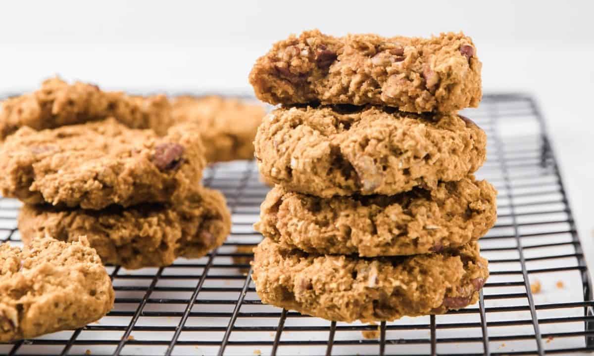 stack of four pumpkin oatmeal cookies on a cooling rack and a few more on the back