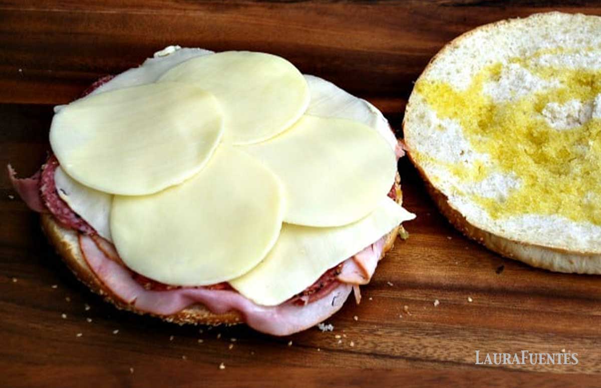 meat and cheese spread out on muffuletta round bread