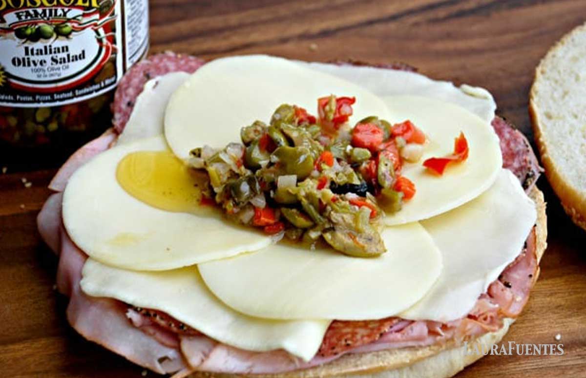 muffuletta sandwich with olive salad on top