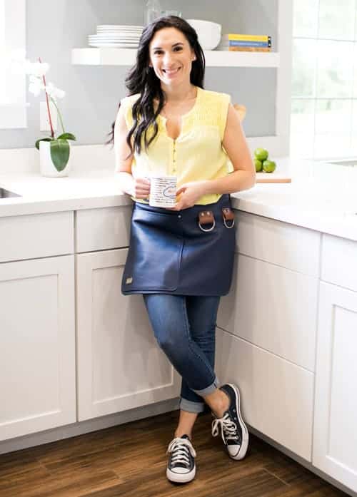 Laura Fuentes standing in the kitchen with a cup of coffee