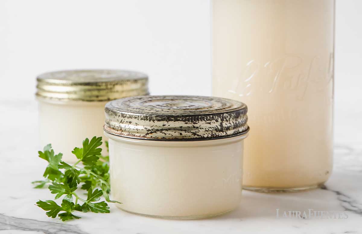 Three full mason jars of homemade chicken broth