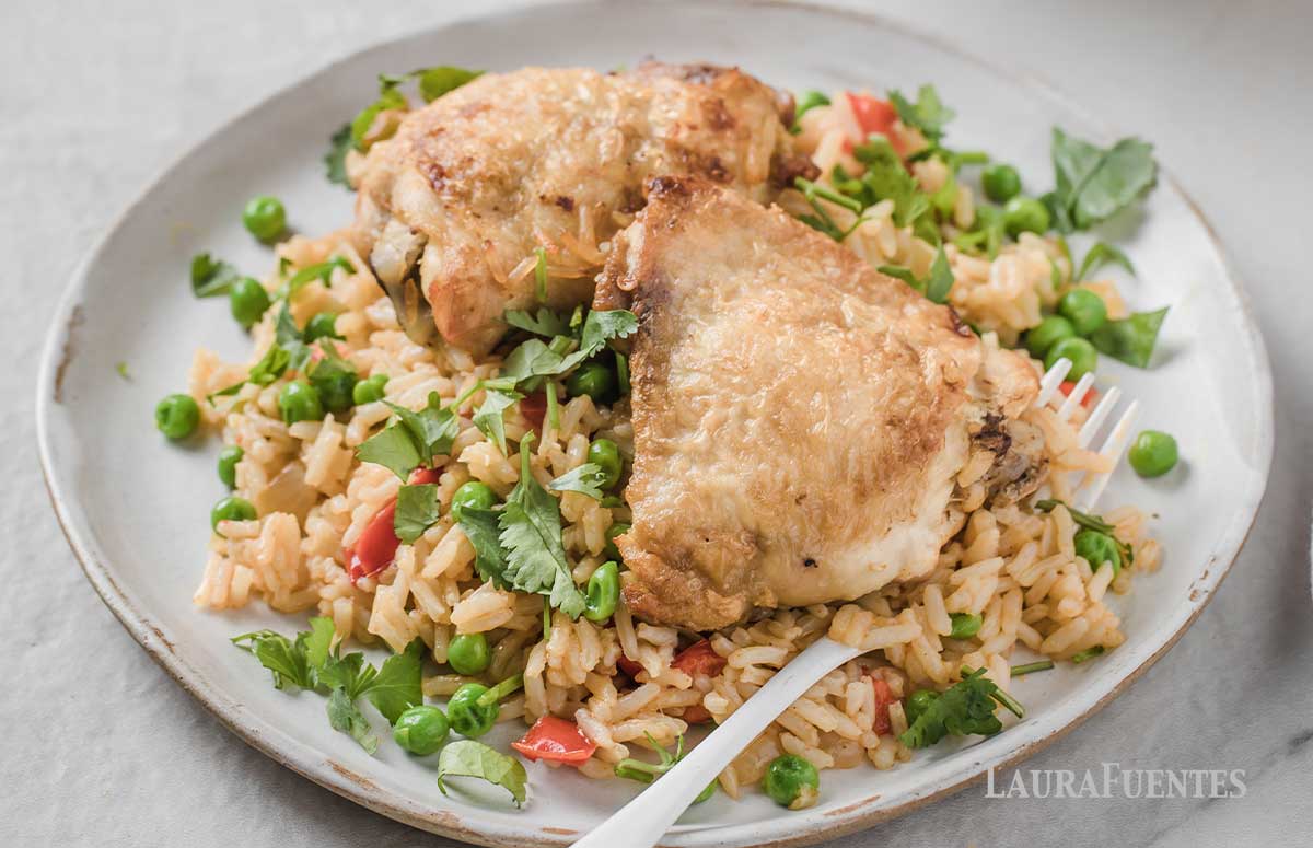 Plate topped with rice, vegetables and Spanish Chicken