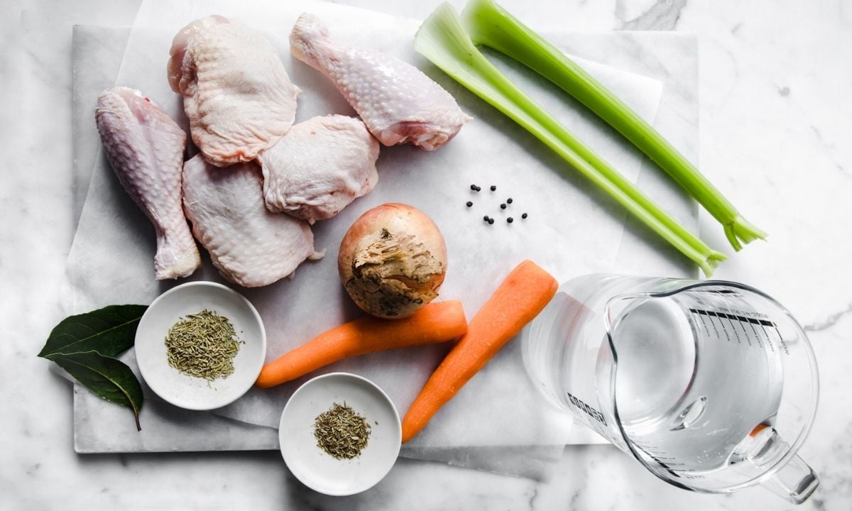 chicken pieces, carrots, celery, onion, bay leaves, dried rosemary, dried thyme, peppercorns, and water