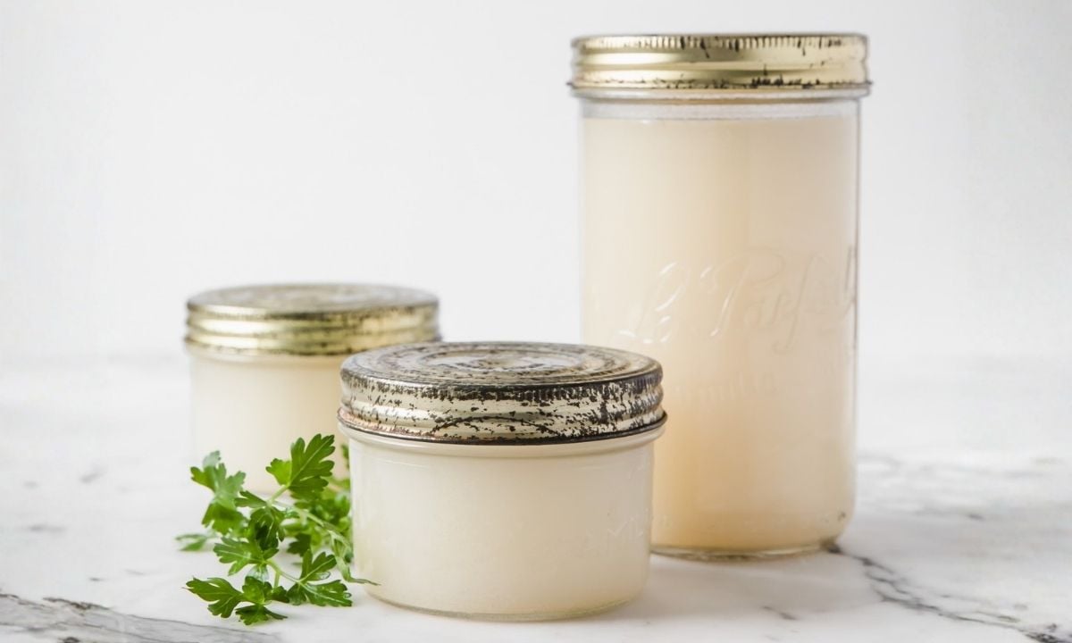 three jars with homemade chicken broth