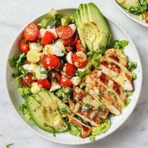 top view of caprese salad topped with Blackened chicken and avocado