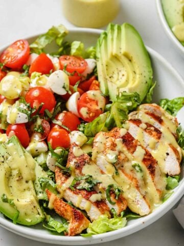 caprese salad topped with Blackened chicken and avocado