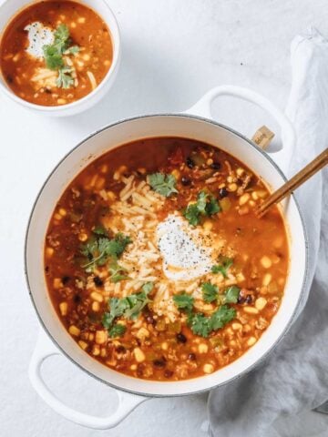 top view of taco soup in a large pot and in a bowl