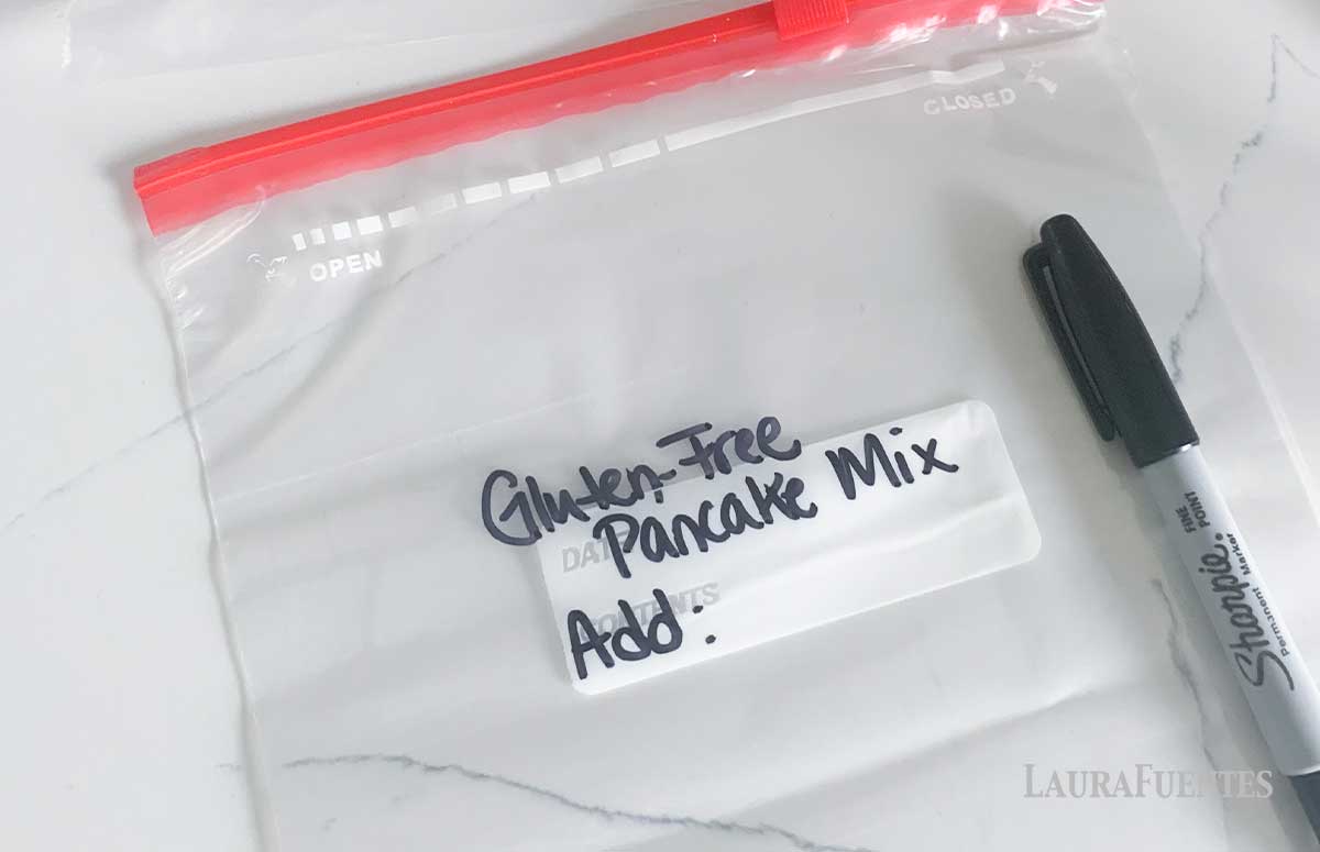 Image: empty zip bag written on with black marker reading "Gluten-Free Pancake Mix Add:" 
