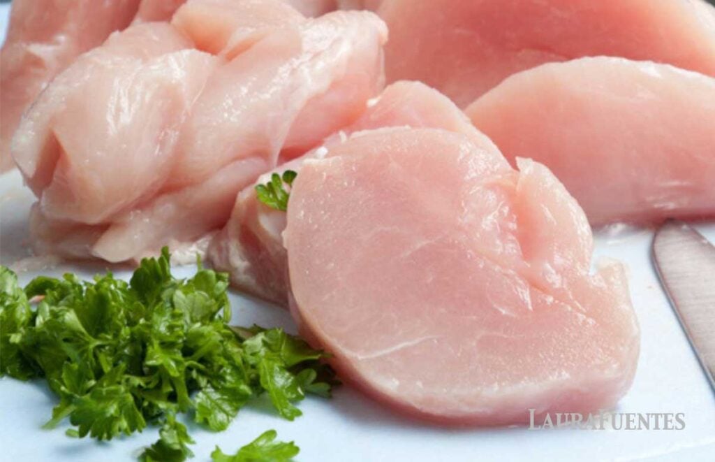 image: three raw chicken breasts laid out to thaw 