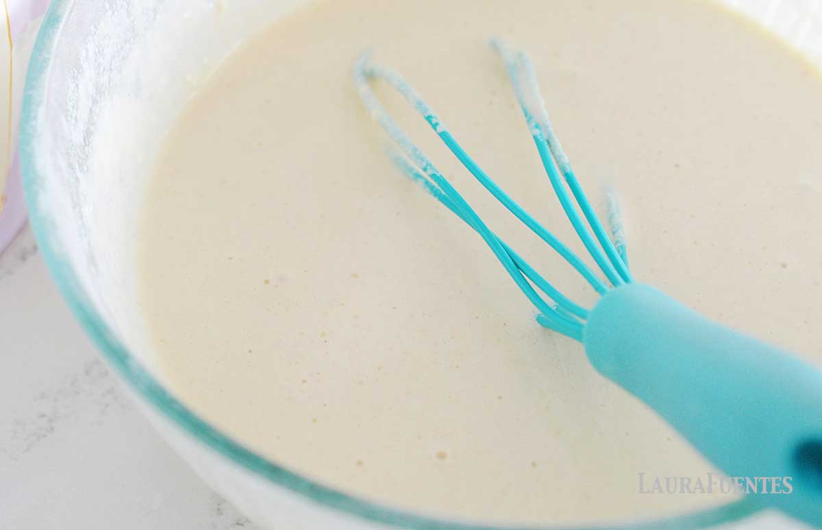 large bowl of pancake batter with turquoise whisk