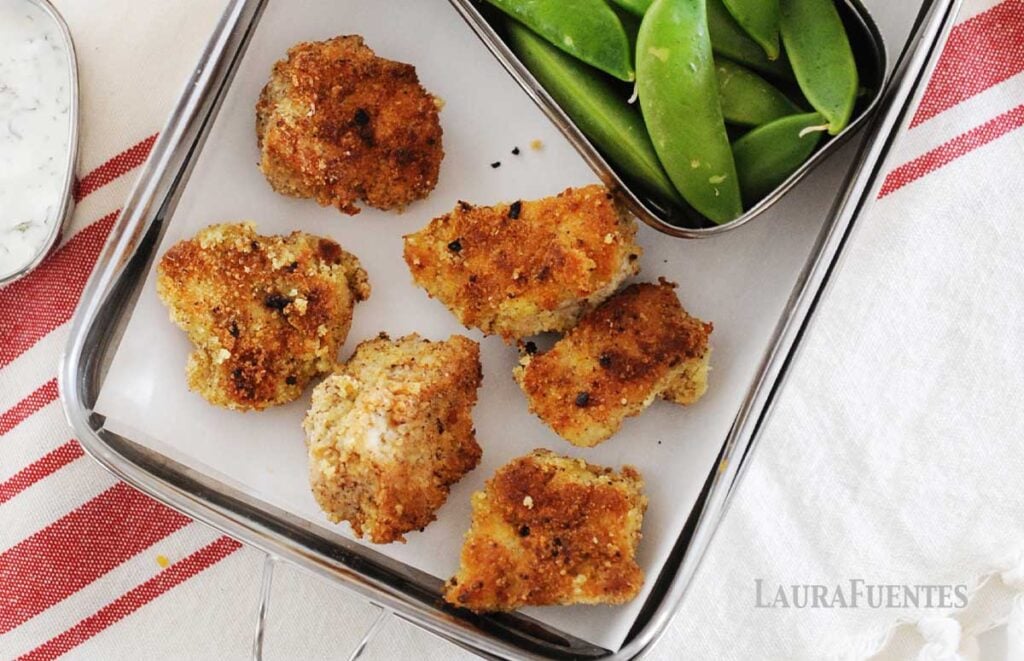 lunchbox with six copycat chick-fil-a nuggets and veggies on the side.