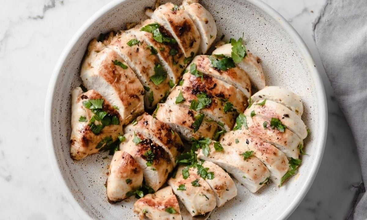 three chicken breasts in a shallow dish