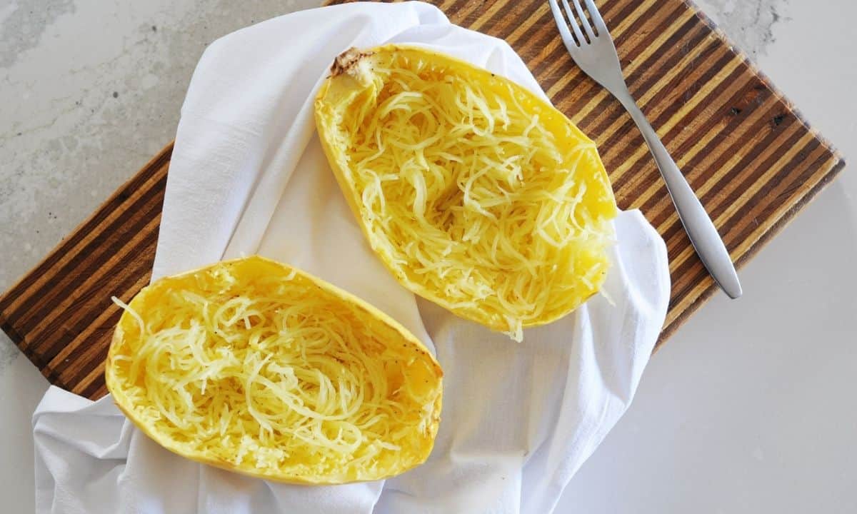 two spaghetti squash halves with squash made into "noodles" inside the skin.