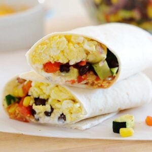 two halves of a veggie breakfast burrito on a countertop