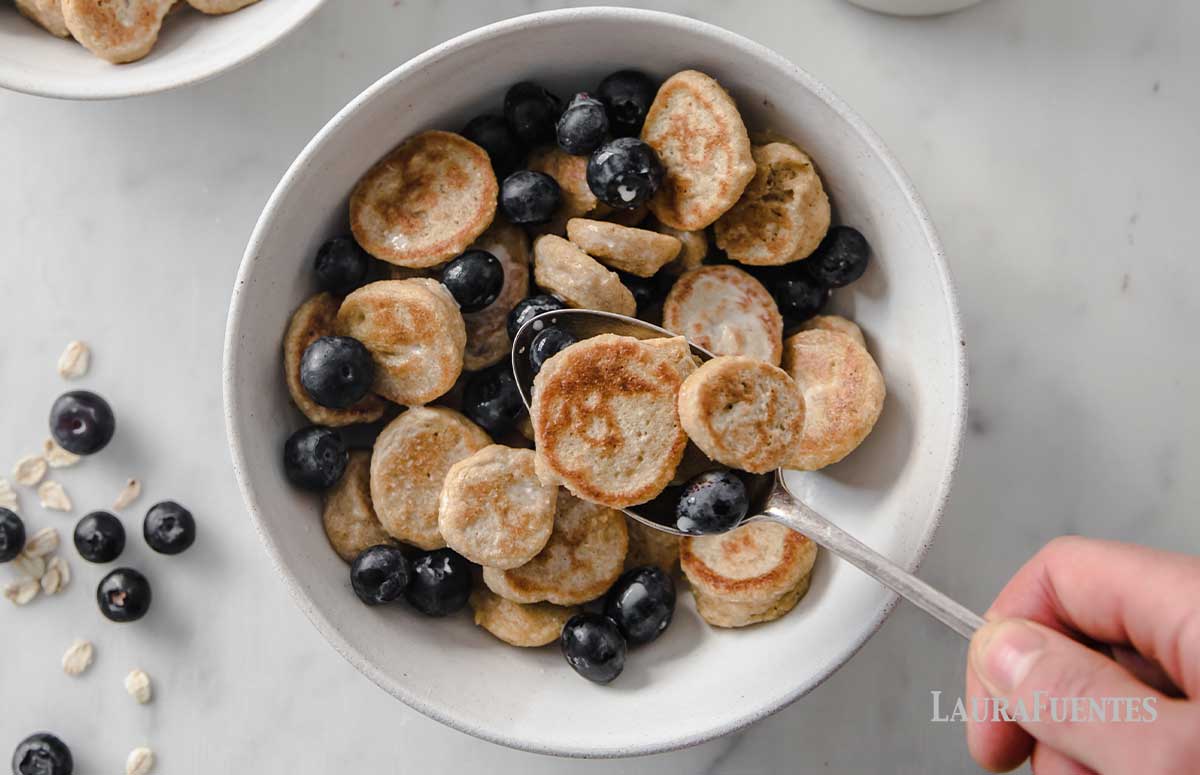 large bowl of pancake cereal with milk and blueberries
