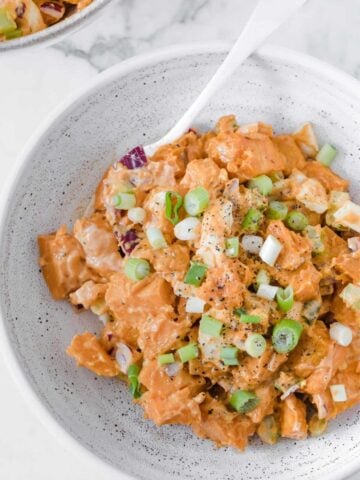 top view of a white bowl with sweet potato salad