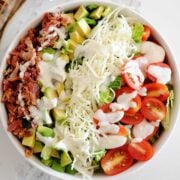 huge blt salad with dressing in a bowl