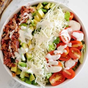 huge blt salad with dressing in a bowl