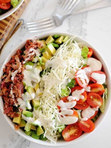 huge blt salad with dressing in a bowl