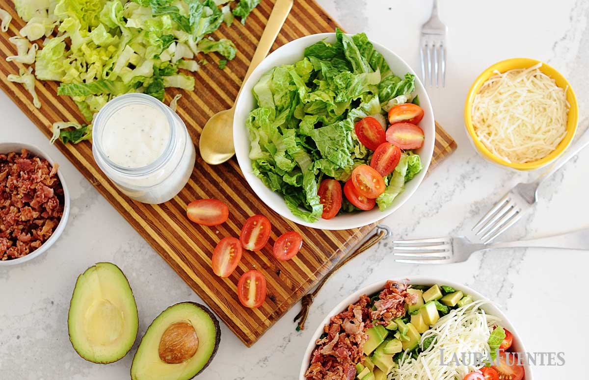deconstructed blt salad surrounded by ingredients of blt salad