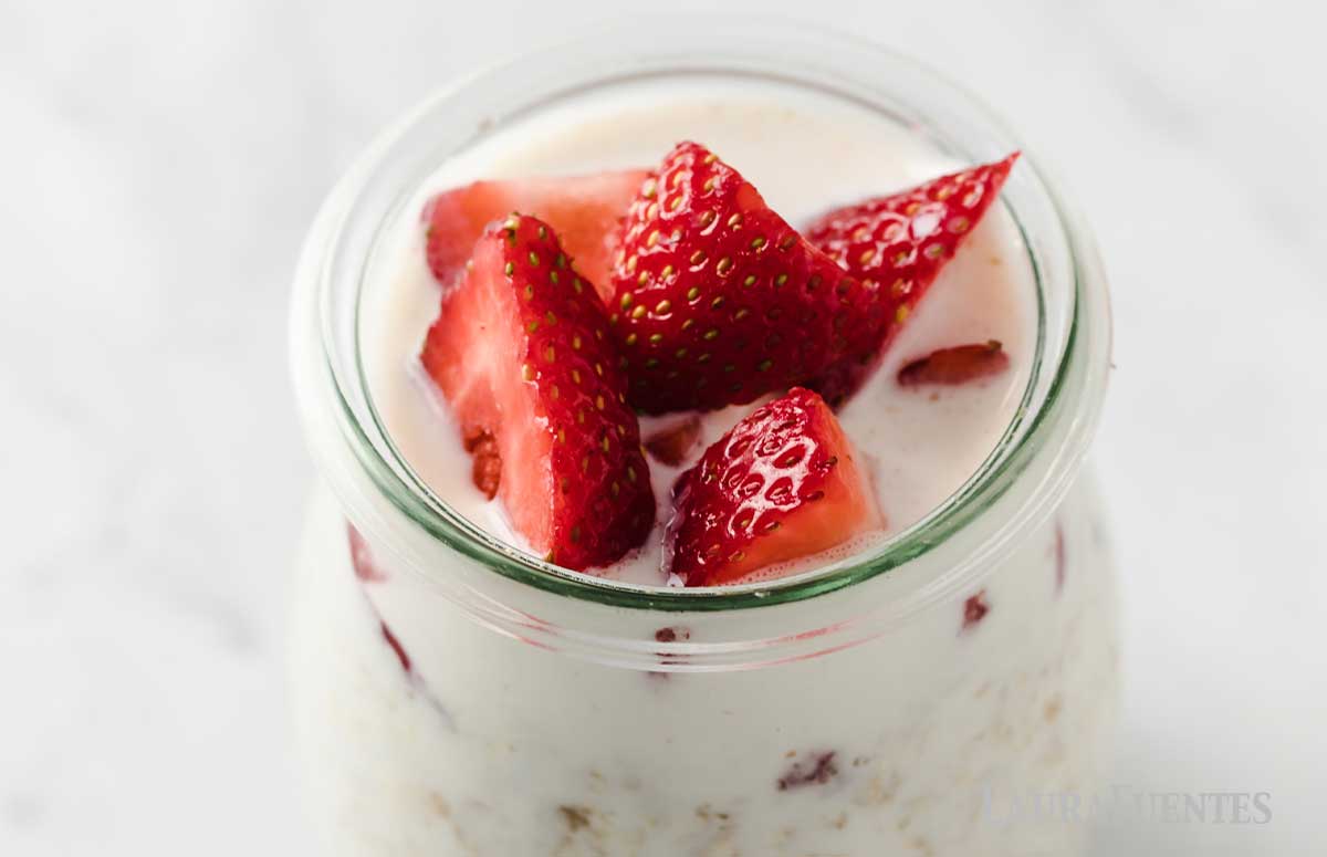 closeup on single jar filled with strawberry overnight oats