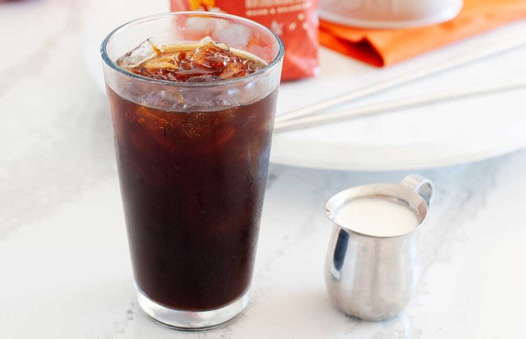 Instant iced coffee with a small pitcher of cream
