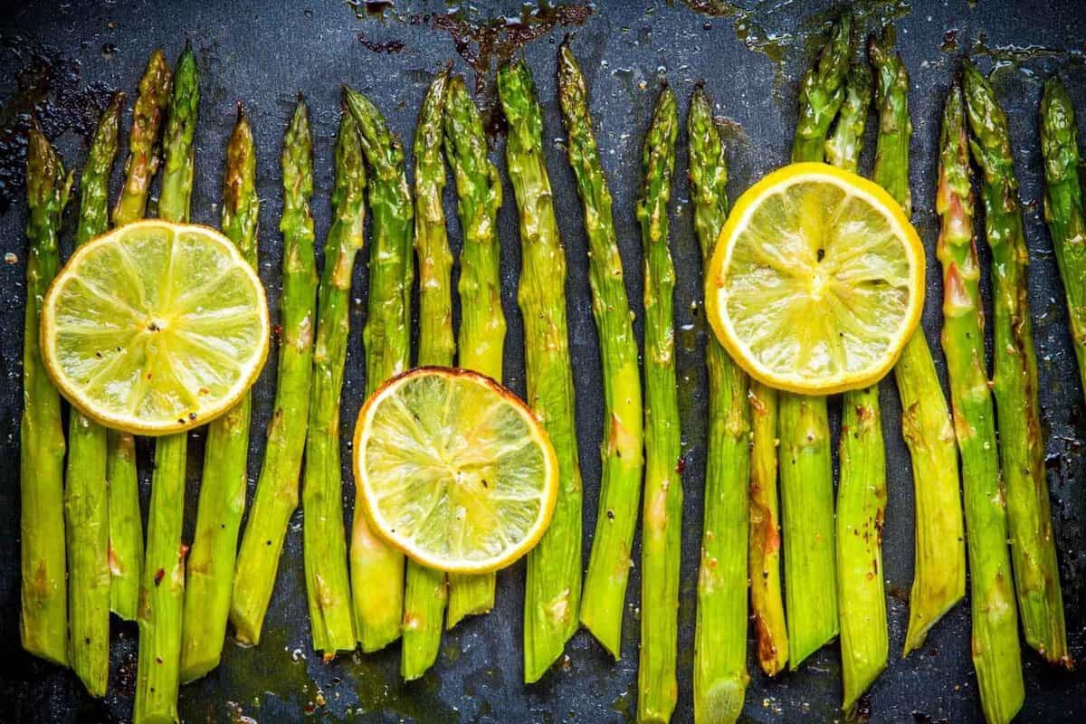 overhead view of roasted asparagus with lemon slices