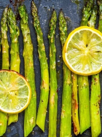 overhead view of roasted asparagus with lemon slices