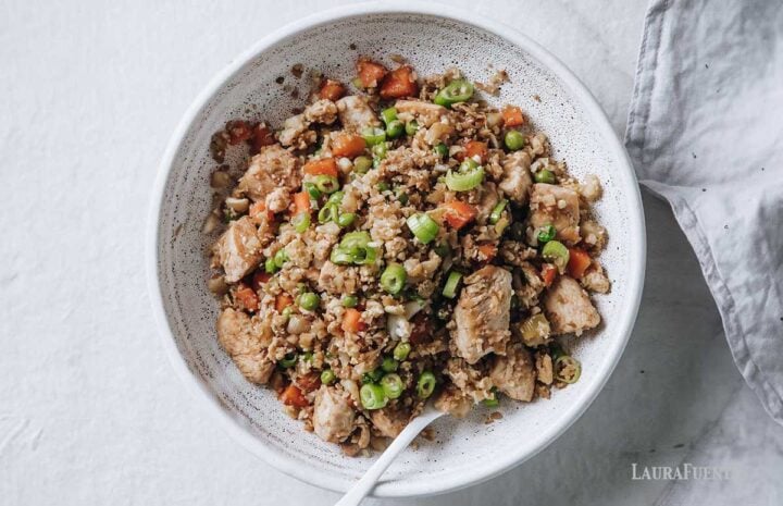 overhead view of white bowl filled with chicken fried cauliflower rice