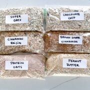six homemade flavored oatmeal packets labeled and lined up on a countertop