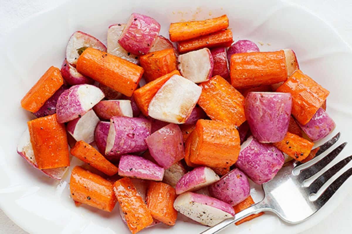 roasted radishes and carrots in a white dish