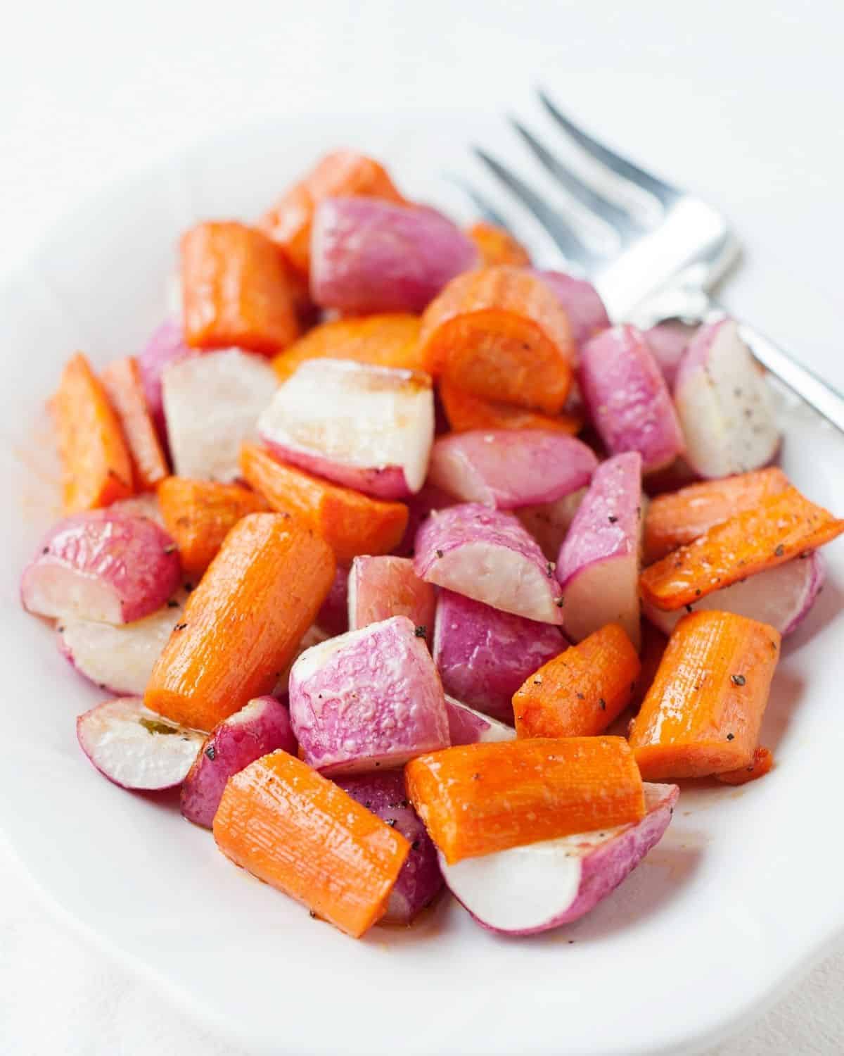 roasted radishes and carrots in a white dish