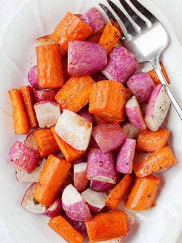 roasted radishes and carrots in a white dish