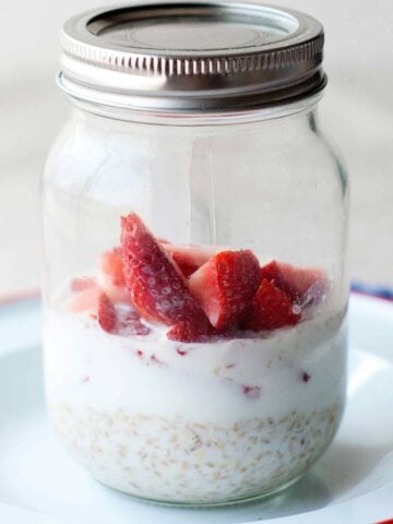 mason jar with overnight oats and strawberry slices