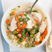overhead view of turkey pot pie soup in a white bowl