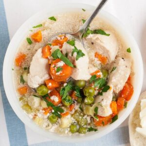 overhead view of turkey pot pie soup in a white bowl