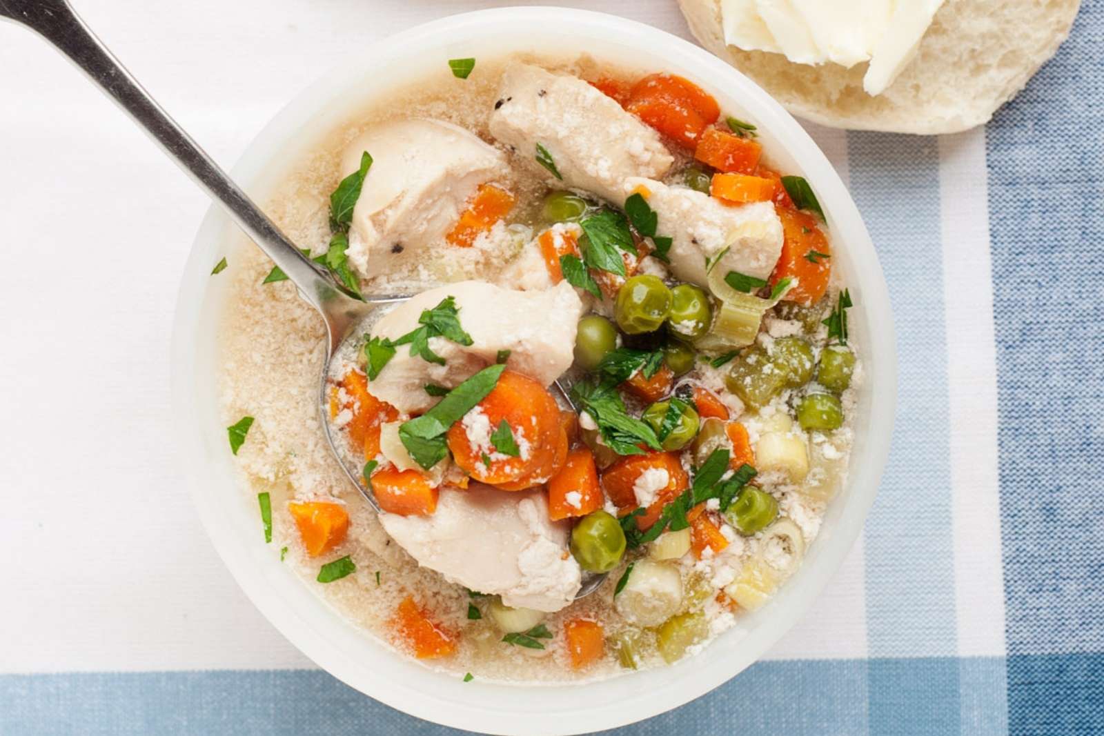 overhead view of turkey pot pie soup in a white bowl