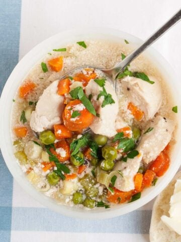 overhead view of turkey pot pie soup in a white bowl